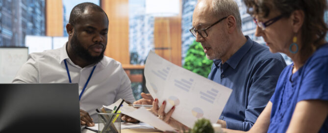 Business professionals in consultation meeting reviewing documents and discussing financing options